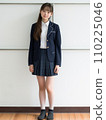 High school girl standing in front of school 110225046