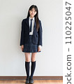 High school girl standing in front of school 110225047