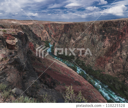 Landscape with panorama of Black Charyn Canyon in Kazakhstan in summer under cloudy sky Landscape with panorama of Black Charyn Canyon in Kazakhstan in summer under cloudy sky 110225528