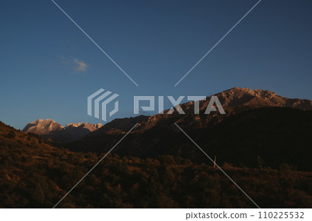 landscape with mountain peaks background sky with clouds at sunset in autumn landscape with mountain peaks background sky with clouds at sunset in autumn 110225532
