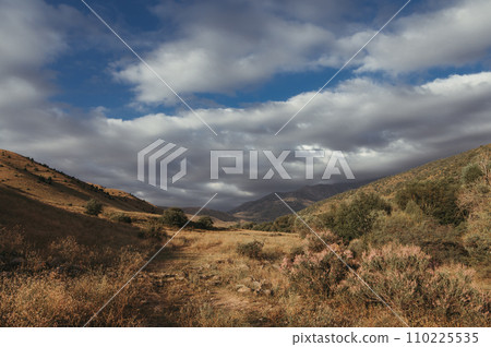 autumn valley with mountain view with cloudy sky autumn valley with mountain view with cloudy sky 110225535