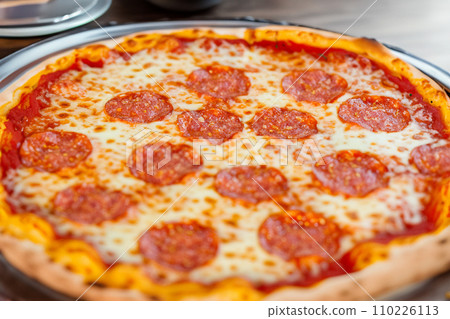 Pizza. Homemade pizza. Delicious pizza. Freshly made Italian margherita pizza with buffalo mozzarella and basil. Pizza with cheese, tomato sauce. Wood oven. World Pizza Day. February 9. 2024. 110226113