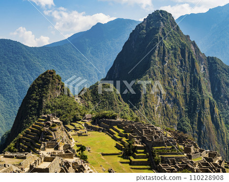 Panoramic view of the lost inca city Machu Picchu, with ruins of the old town, agricultural terraced fields and Huayna Picchu peak in background, Sacred valley of Incas, Cusco region, Peru 110228908