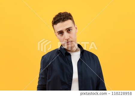 Young sad furious man wearing casual clothes looking at camera 110228958