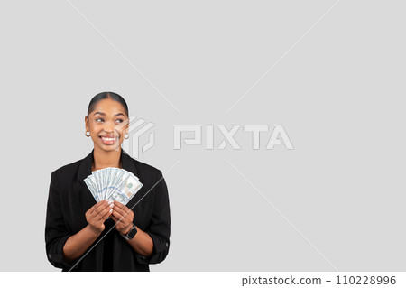 Happy pretty young african american lady in formal suit show many money dollars Happy pretty young african american lady in formal suit show many money dollars 110228996