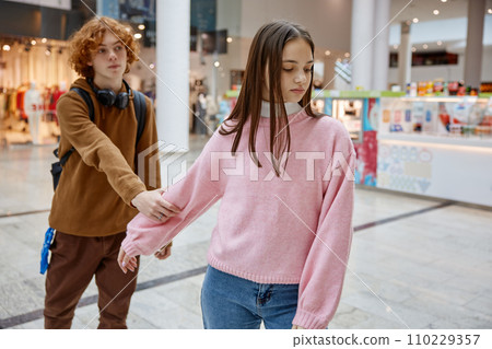 Teenage couple having quarrel during date in shopping center Teenage couple having quarrel during date in shopping center 110229357