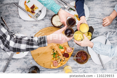 people clanging glasses together having pizza people clanging glasses together having pizza 110229933