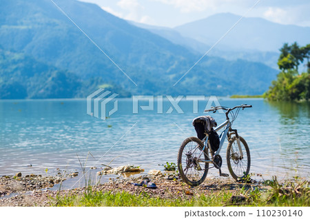 Bicycle left near shoreline, Pokhara, Nepal 110230140