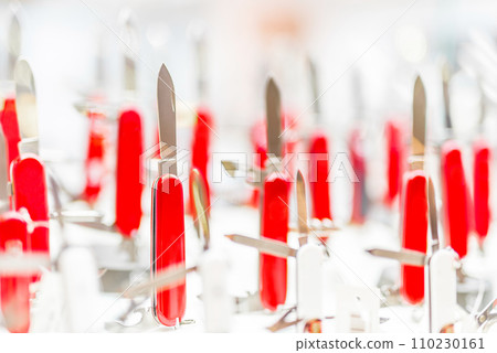 red folding knives on a counter 110230161