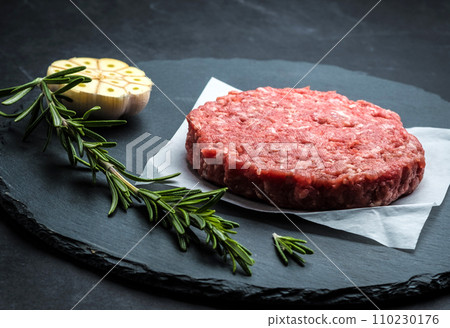 Raw burger beef patty on stone background 110230176