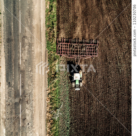 tractor plowing field, top view tractor plowing field, top view 110230786