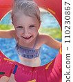 Baby girl smiling in swimming pool. Child having fun in swimming pool 110230867