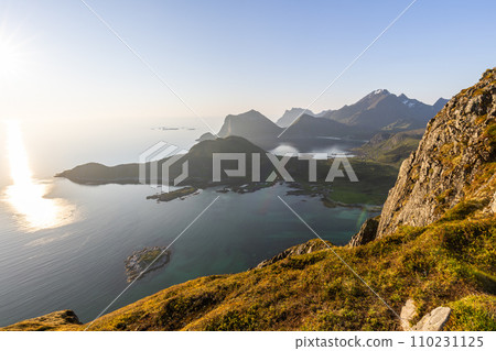 Ethereal sunlight over Lofoten's terrain, with midnight sun above Nappstraumen 110231125