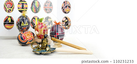 Master Class teaching people to draw on eggs for Easter patterns pysachok for painting pysankas with wax on a white background banner place for text on the background colorful eggs in the book lesson Master Class teaching people to draw on eggs for Easter patterns pysachok for painting pysankas with wax on a white background banner place for text on the background colorful eggs in the book lesson 110231233