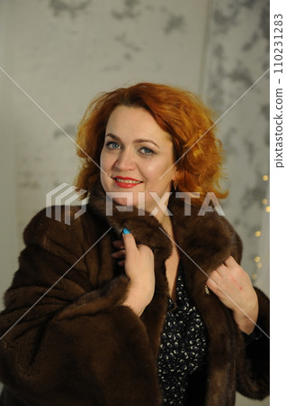 Portrait of smiling woman looking at camera with crossed arms. Happy girl standing in creative office. Successful businesswoman standing in office with copy space. 110231283