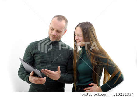 guy with a girl choose a computer inspection of a new gadget purchase communications internet 110231334