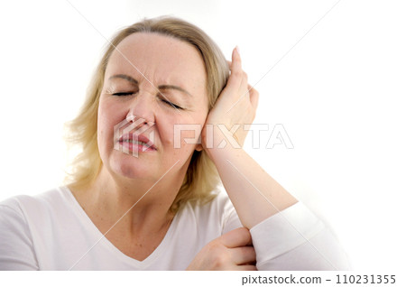 headache middle-aged adult woman interferes with noise displeased face hurts head pain in the ear white background white jacket unpleasant negative emotions fatigue age experiences ecology headache middle-aged adult woman interferes with noise displeased face hurts head pain in the ear white background white jacket unpleasant negative emotions fatigue age experiences ecology 110231355