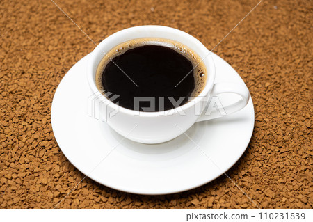A cup of hot instant coffee on a background of freeze-dried granules A cup of hot instant coffee on a background of freeze-dried granules 110231839