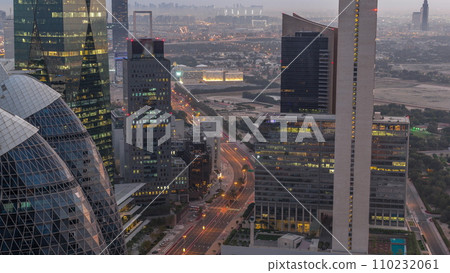 Skyline view of the high-rise buildings in International Financial Centre in Dubai aerial night to day timelapse, UAE. Skyline view of the high-rise buildings in International Financial Centre in Dubai aerial night to day timelapse, UAE. 110232061
