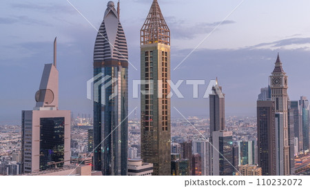 Skyline view of the high-rise buildings on Sheikh Zayed Road in Dubai aerial night to day timelapse, UAE. Skyline view of the high-rise buildings on Sheikh Zayed Road in Dubai aerial night to day timelapse, UAE. 110232072