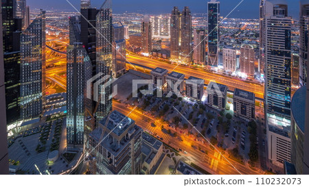 High-rise buildings on Sheikh Zayed Road in Dubai aerial night to day timelapse, UAE. 110232073