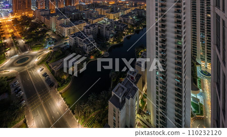 Pond and low rise buildings in Greens district aerial all night timelapse. 110232120