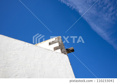 Typical white archtecture and blue sky with chemtrails 110233041