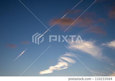 Colorful clouds on a blue sky and chemtrail Colorful clouds on a blue sky and chemtrail 110233084