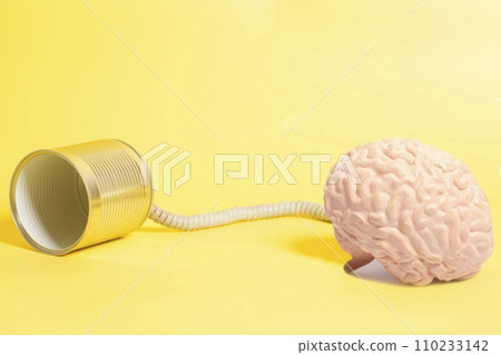tin can phone with human brain anatomical model. communication concept tin can phone with human brain anatomical model. communication concept 110233142