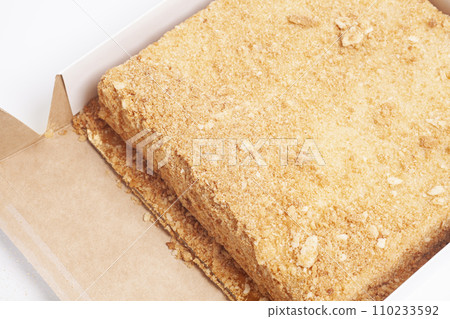 Napoleon cake in a cardboard box. Top view. Napoleon cake in a cardboard box. Top view. 110233592