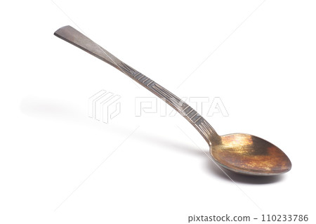 Old teaspoon isolated on white background Old teaspoon isolated on white background 110233786