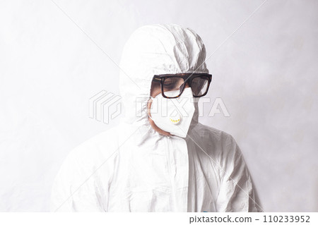 Doctor scientist in white coverall suit, mask and glasses. Dispersal and research of dangerous viruses and bacteria radiation concept. Doctor scientist in white coverall suit, mask and glasses. Dispersal and research of dangerous viruses and bacteria radiation concept. 110233952