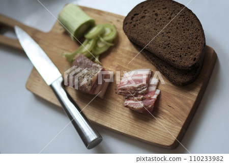 bacon, leeks, black bread and a knife 110233982