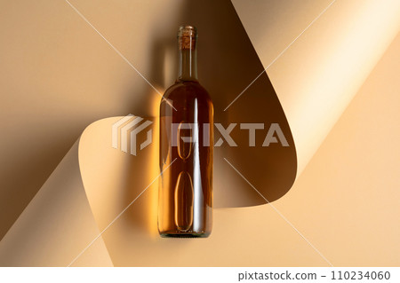 Bottle of white wine on a beige background. Bottle of white wine on a beige background. 110234060