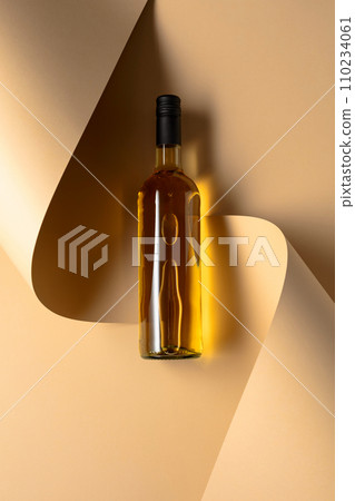 Bottle of white wine on a beige background. Bottle of white wine on a beige background. 110234061
