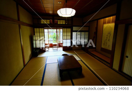 A Japanese-style room with tatami flooring, designed in the style of a traditional inn. 110234068