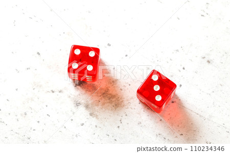 Two red craps dices showing Natural or Seven Out (number 4 and 3) overhead shot on white board 110234346