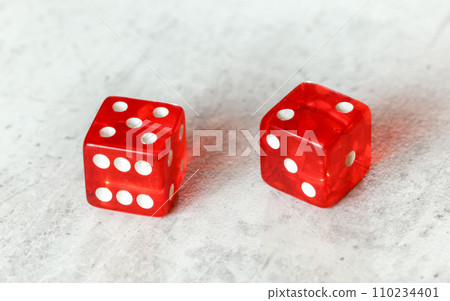 Two translucent red craps dices on white board showing Natural or Seven Out (number 5 and 2) 110234401