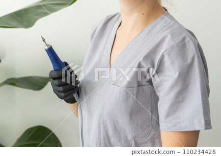 Electric nail file drill manicure machine with fraser close up on light background with copy space Electric nail file drill manicure machine with fraser close up on light background with copy space 110234428