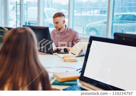 Serious fellows reading in library 110234797