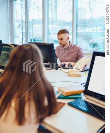 Serious fellows reading in library 110234798