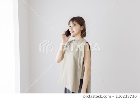 A young lady speaking on a smartphone A young lady speaking on a smartphone 110235730