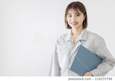 一個穿著工作服的女人拿著剪貼板 一個穿著工作服的女人拿著剪貼板 110235786