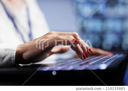 Skillful professional using laptop to make sure valuable data remains shielded from security complications, safeguarding high tech place against unauthorized access and vulnerabilities, close up Skillful professional using laptop to make sure valuable data remains shielded from security complications, safeguarding high tech place against unauthorized access and vulnerabilities, close up 110235983