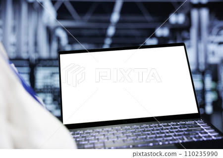 Close up shot of mock up laptop used by adept IT admin in data center delivering massive computing power, capable of processing and storing vast amounts of datasets and controlling network resources 110235990