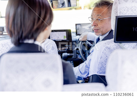 Business woman telling taxi driver where to go Business woman telling taxi driver where to go 110236061