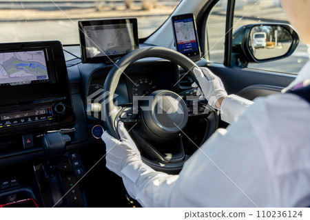 Taxi driver steering wheel hands faceless 110236124