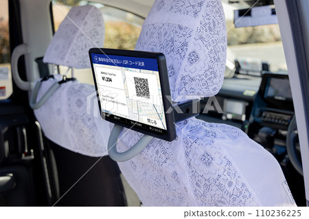 A monitor installed behind the driver's seat in a taxi 110236225