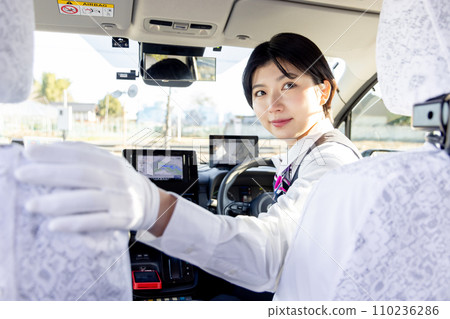 A female taxi driver checking the rear view A female taxi driver checking the rear view 110236286