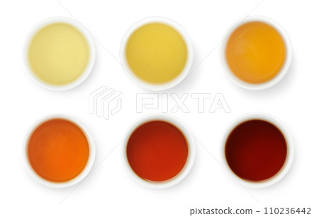Brewed Chinese teas of different color in white bowls, top view isolated on white 110236442